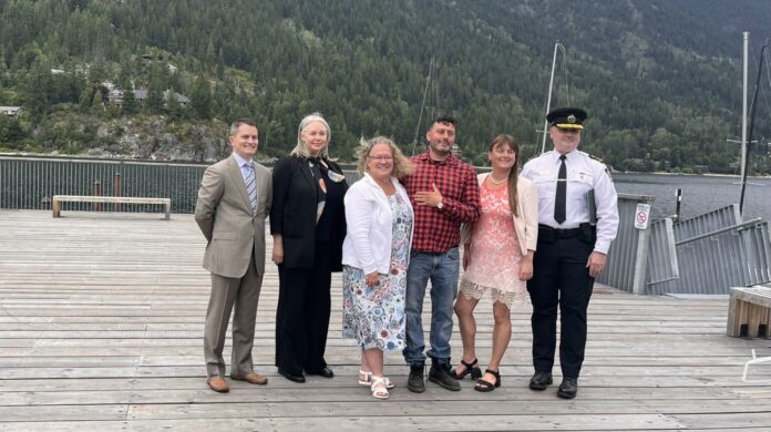 This is a photo of Lannon Da Best of Interior Health, Solicitor General Nina Krieger, Mayor Janice Morrison, Nelson street outreach member Jeremy Kelly, MLA Brittny Anderson and police Chief Donovan Fisher. Farnworth was in Nelson on Friday to announce the launch of HealthIM.