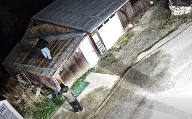 This is a photo of two individuals breaking into the cart barn at Granite Point Golf Club